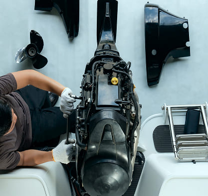 Marine technician repairing an outboard boat engine — expert yacht mechanical servicing by Zenith Eset